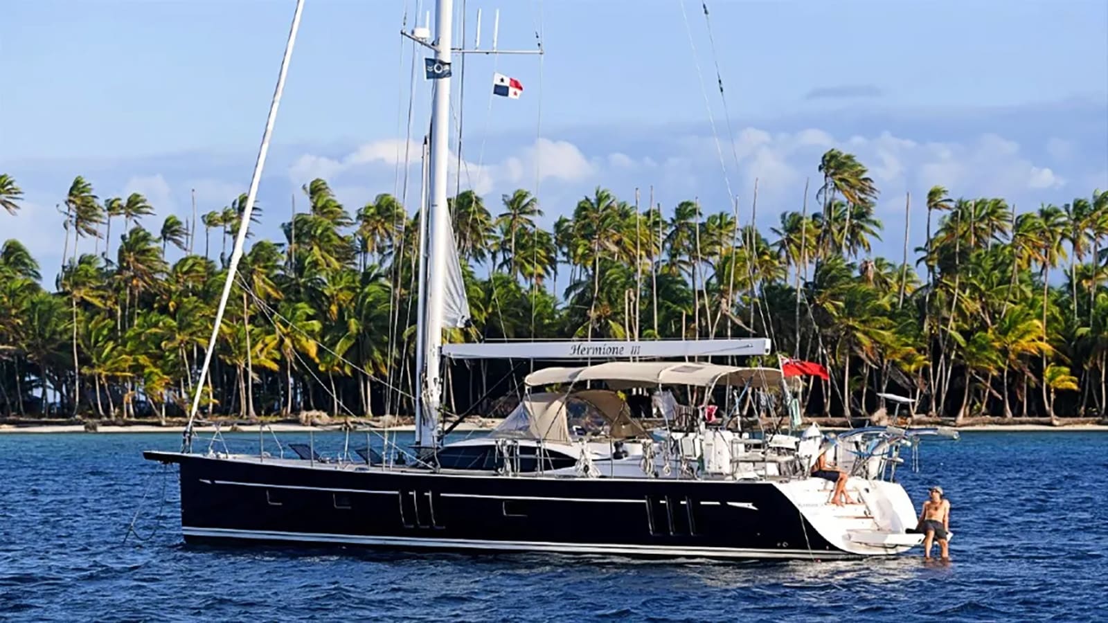 Yacht near the island with people