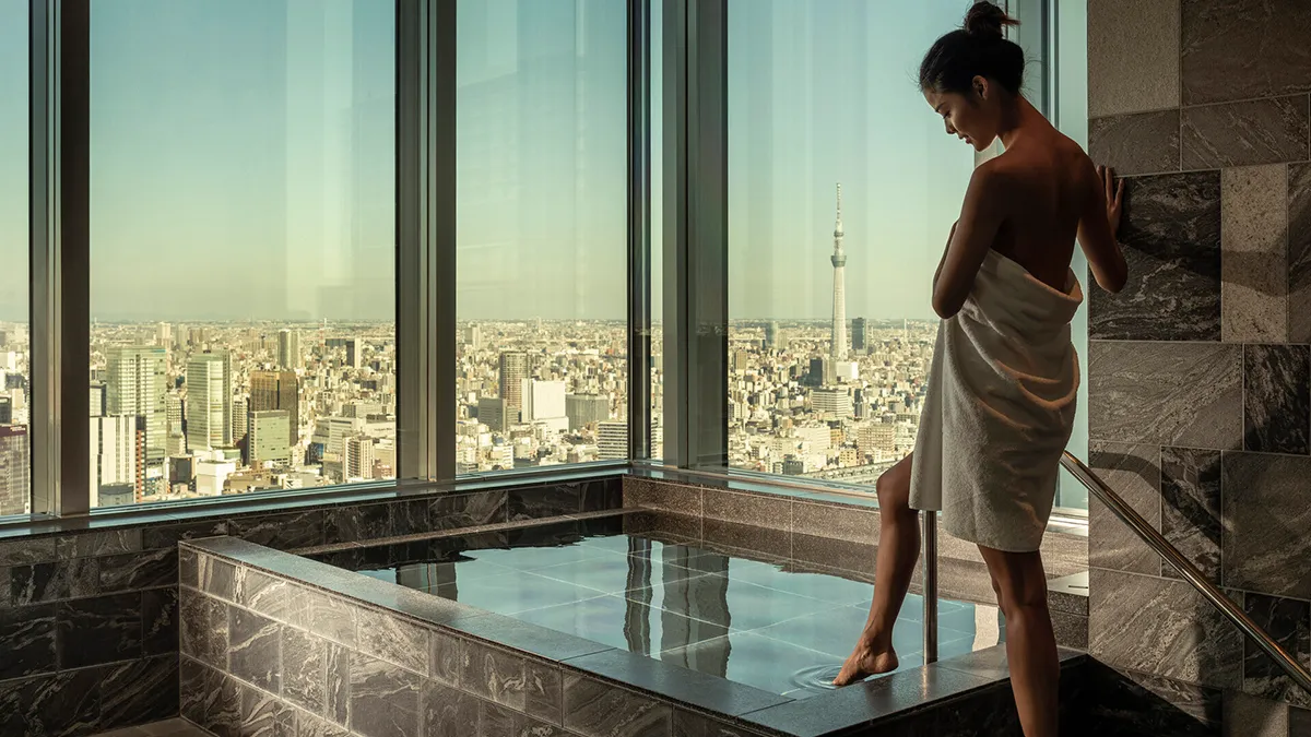 four seasons otemachi spa woman stepping into spa