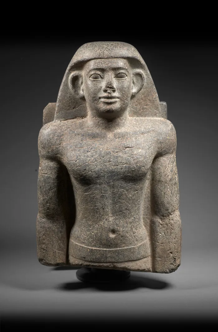 Granite bust of an ancient Egyptian man wearing a nemes headdress with a calm, front-facing expression.