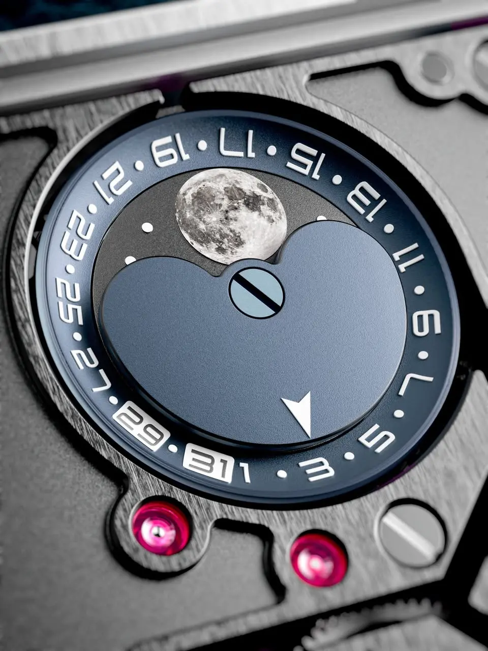 Close-up of a luxury watch dial featuring a blue moon-phase disc and moon image, with a circular date scale around the edge.