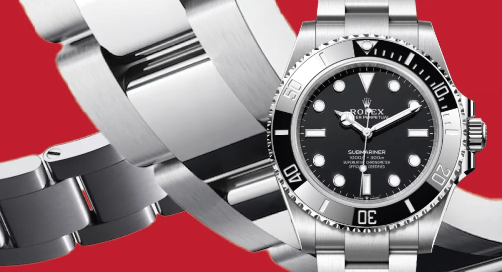 Close-up of a stainless steel Rolex Submariner watch with a black dial and rotating bezel on a red background.