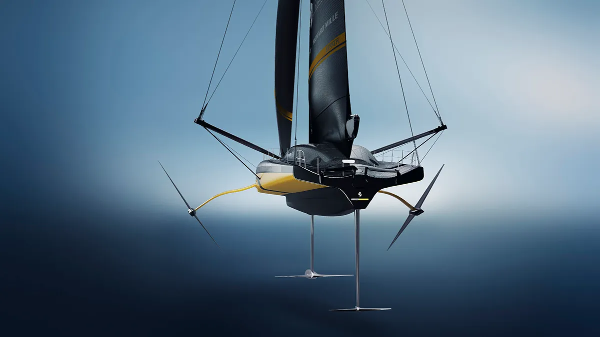 Futuristic hydrofoil sailboat skimming above the ocean with a yellow-accent hull and long foils beneath.