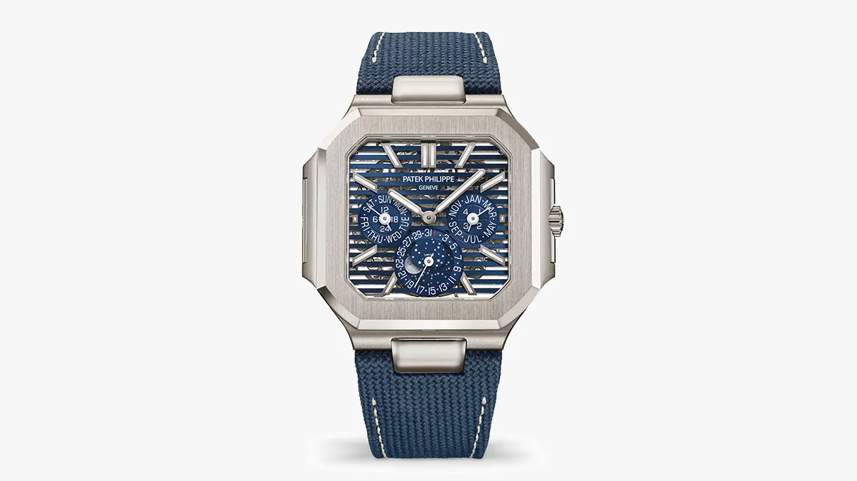 Patek Philippe wristwatch with a blue striped dial, silver case, and blue fabric strap with white stitching
