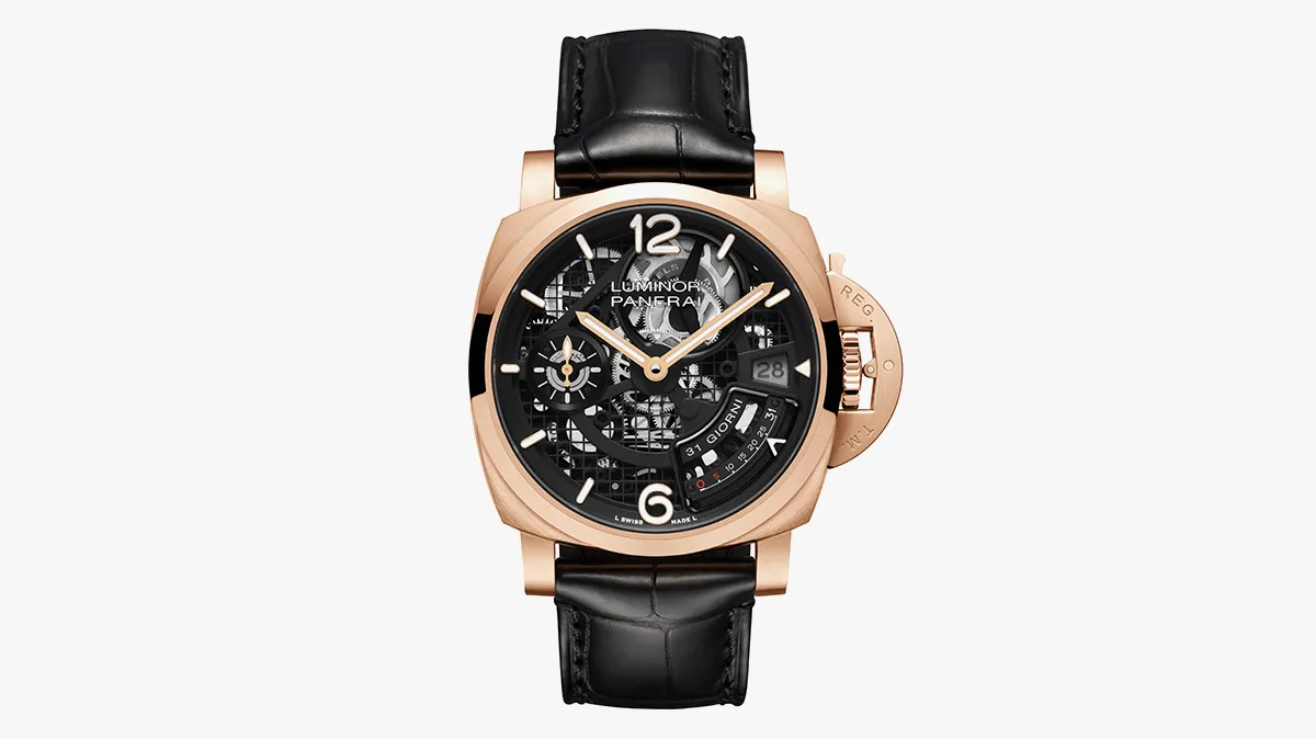 Rose gold skeleton watch with black leather strap, exposed gears and large 12/6 numerals, date window at 3 o'clock