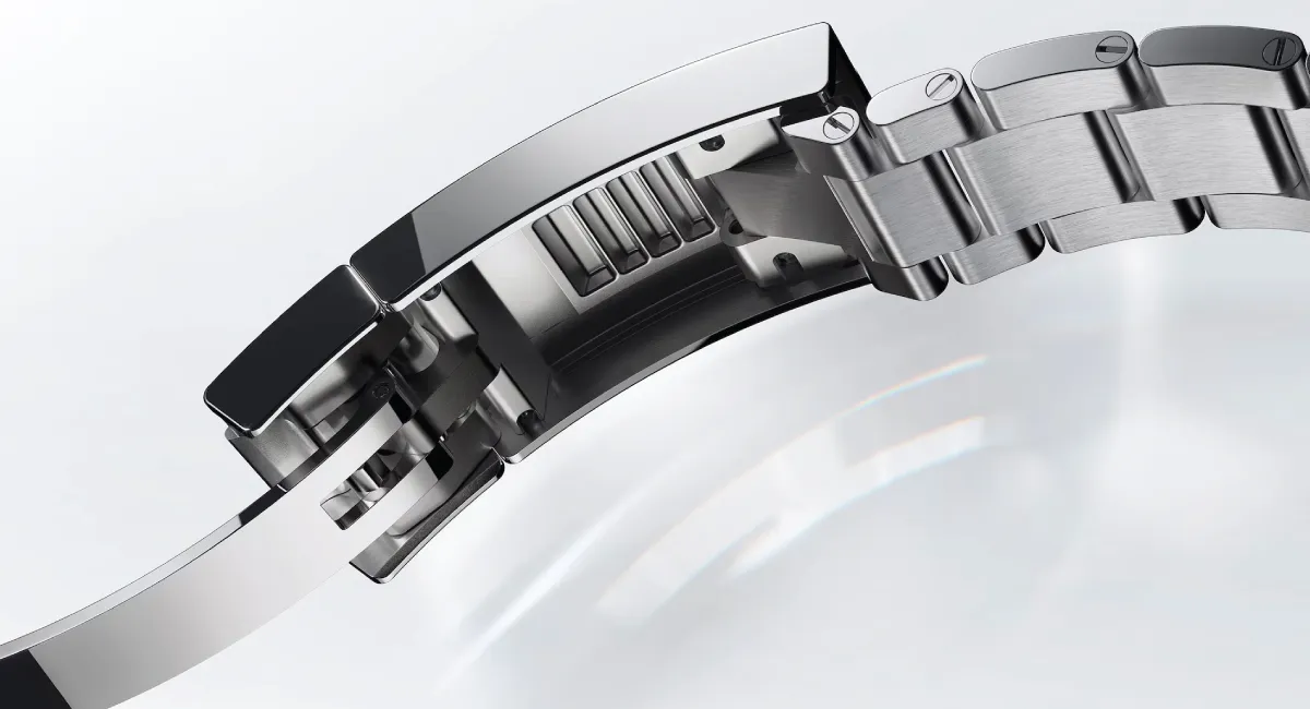 Close-up of a stainless steel watch clasp and linked bracelet, showing the folding deployment mechanism.