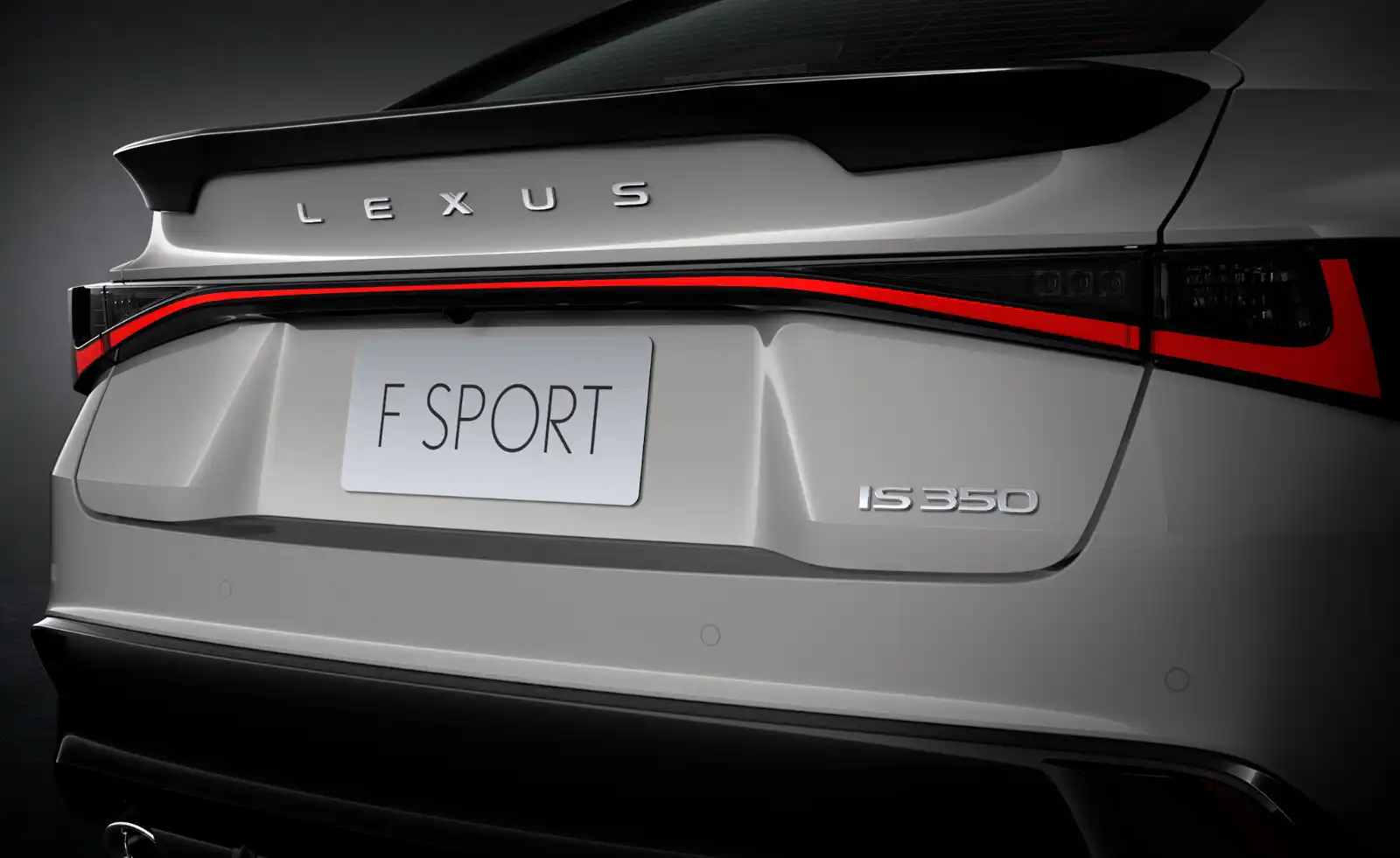 Rear view of a silver Lexus IS 350 F SPORT showing the spoiler and red taillight accent