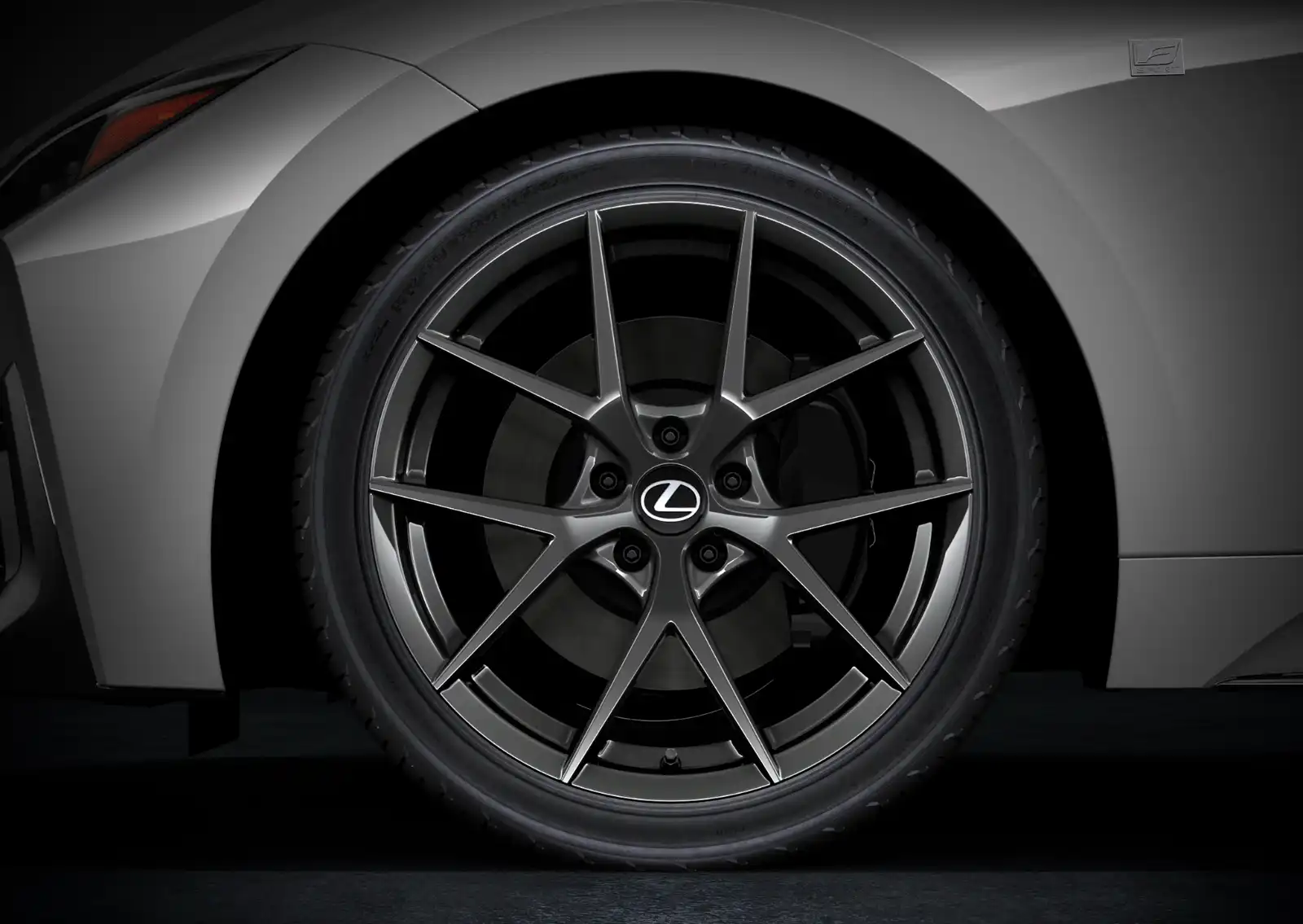 Close-up of a silver multi-spoke Lexus alloy wheel with a low-profile tire.