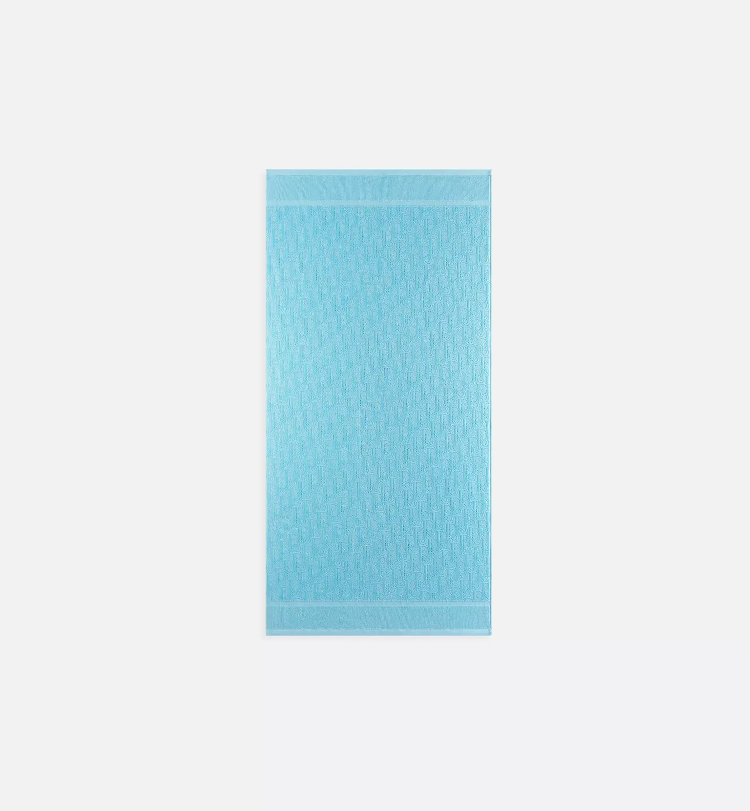 Tall light-blue padded envelope standing upright on a white background, textured surface with a repeating pattern