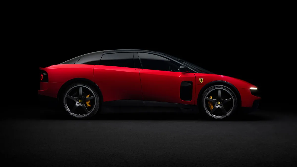Red Ferrari sports car seen from the side in a dark studio setting, highlighting its sleek profile and gold brake calipers.
