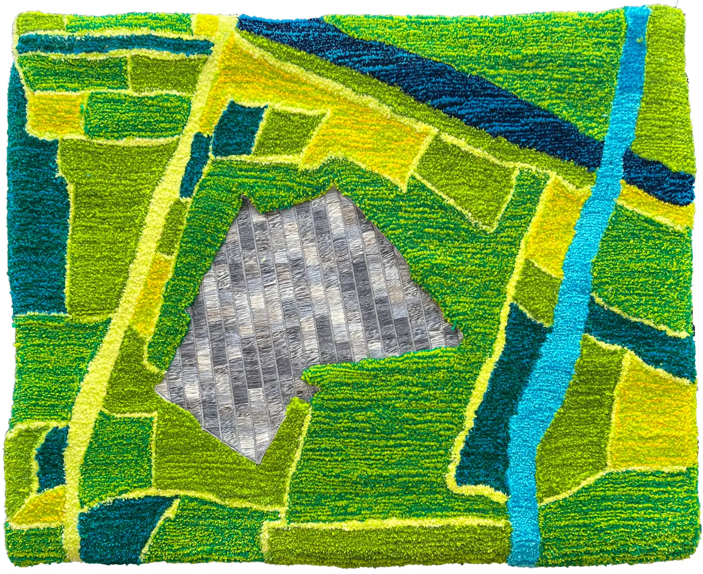 Abstract area rug with bright green, blue, and yellow geometric patches and a silver triangular inset.