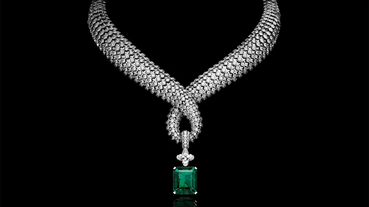 Diamond-encrusted rope necklace with a square emerald pendant hanging center