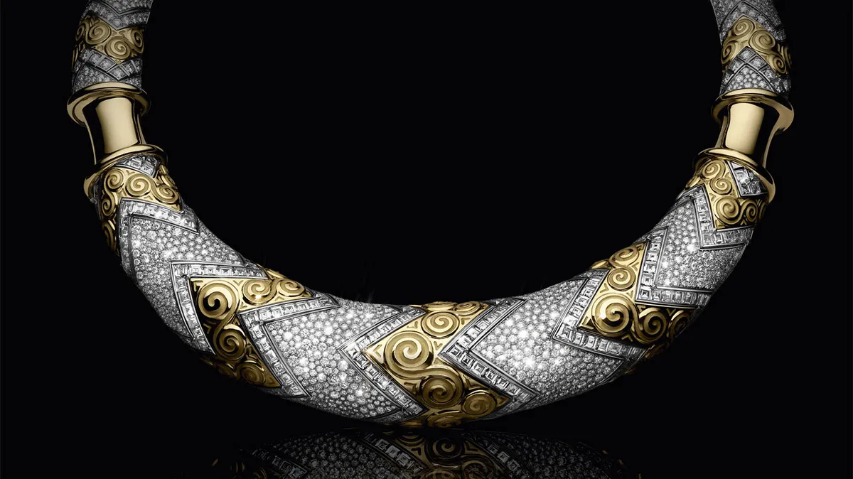 Luxurious gold and diamond collar necklace on a black background. (Informative)