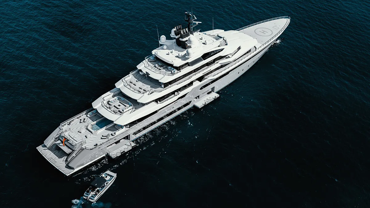 Aerial view of a white multi-deck luxury superyacht in dark blue water, with a small motorboat nearby