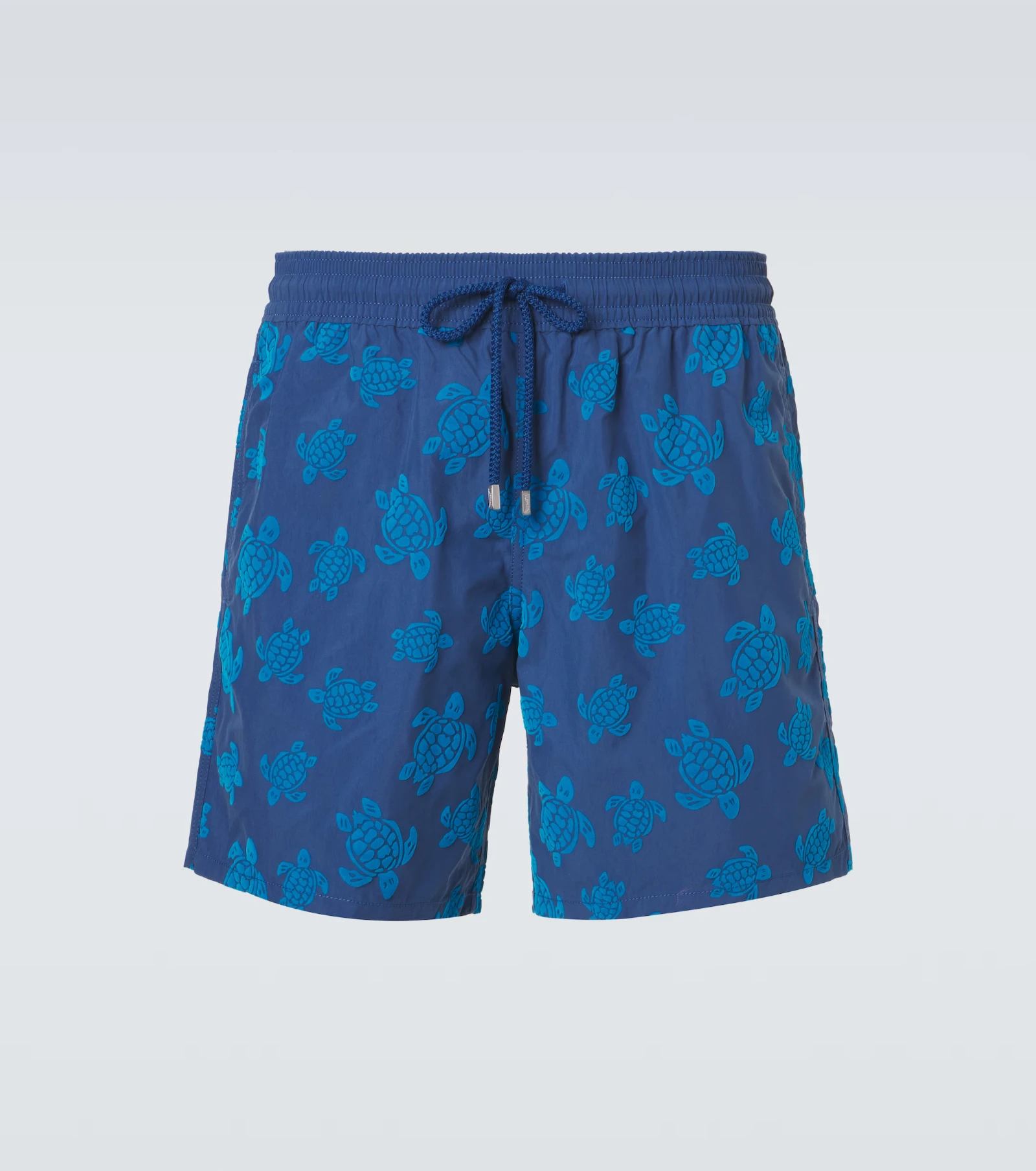 Blue swim shorts with a turquoise turtle print and a drawstring waistband, mid-thigh length visible at center pose.