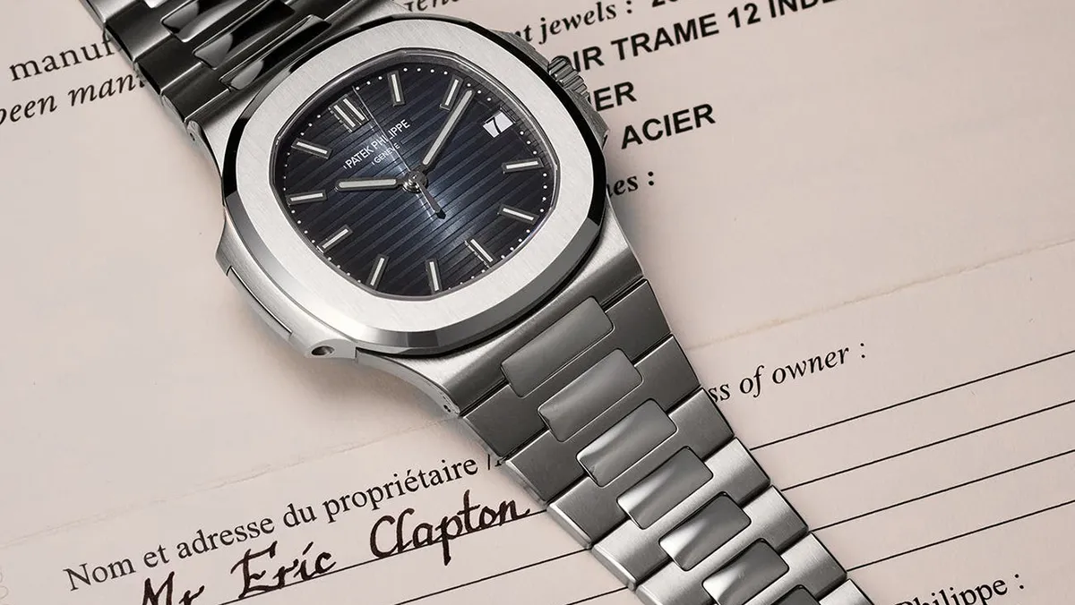Silver Patek Philippe Nautilus on a property deed, with the owner’s name Mr. Eric Clapton visible beneath the bracelet.
