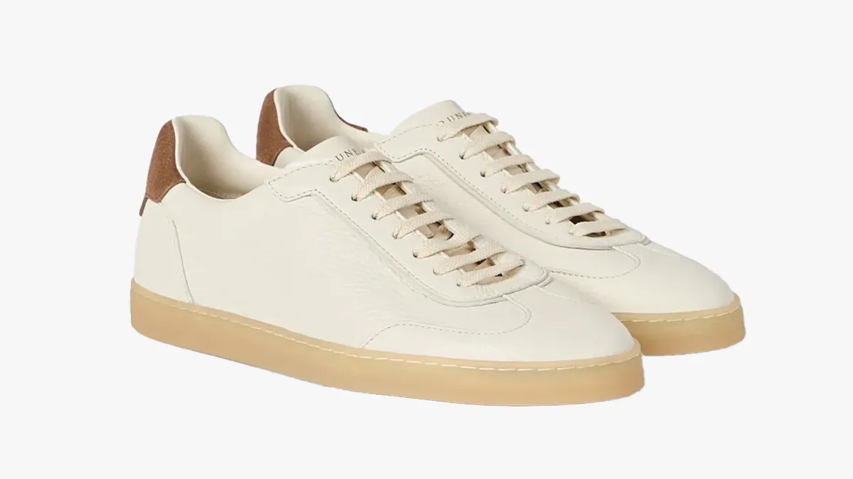 Pair of cream leather sneakers with tan suede heel tabs and gum-colored rubber sole