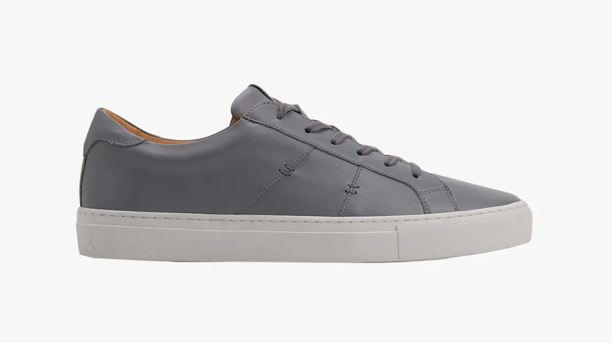 Gray low-top sneaker with a white rubber sole, shown in profile view on a white background.
