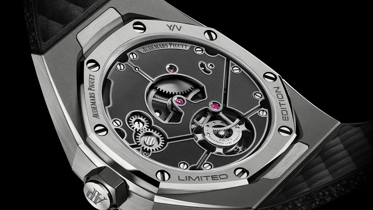 Close-up of a limited edition Audemars Piguet watch back, displaying gears and screws through a transparent case.