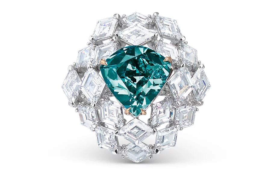 Teal pear-shaped gemstone set in a halo of large square-cut diamonds on a silver ring