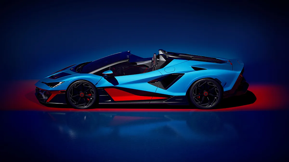 Blue open-top supercar in profile view with black and red accents, on a red-lit studio floor.