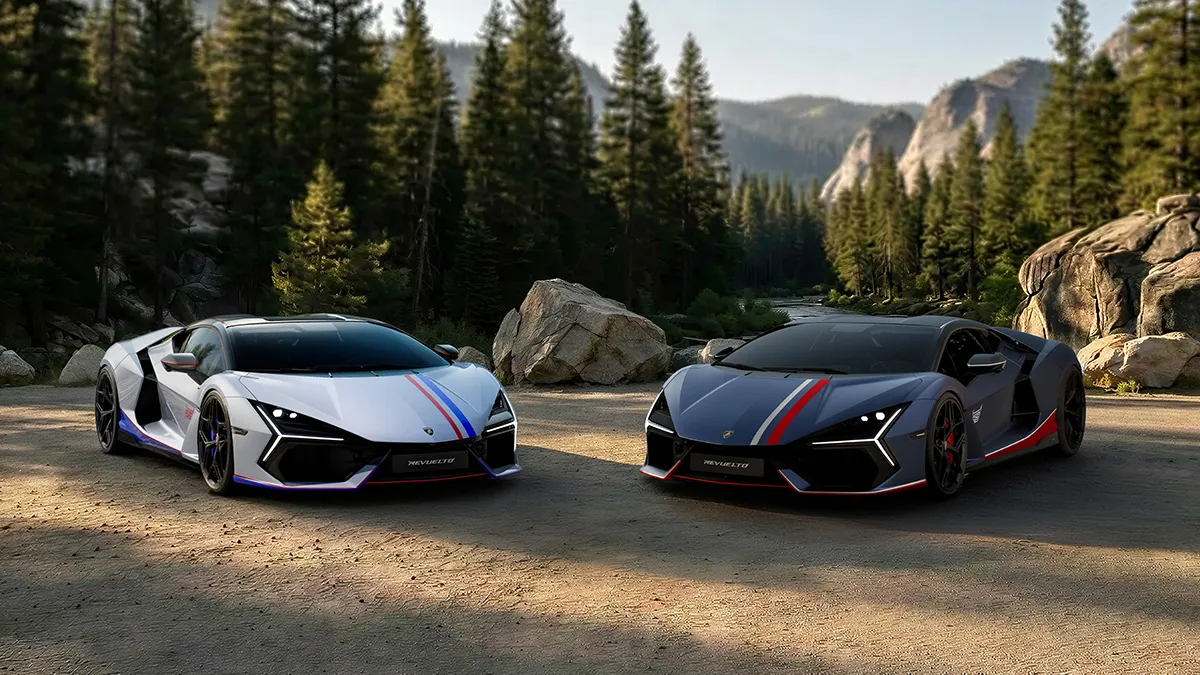 Two Lamborghini Revuelto. NA63 supercars parked side by side on a dirt road in a forested mountain landscape, white with blue stripes and dark blue with red stripes.