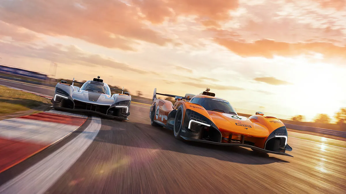 Two race cars—orange and gray—lean into a curve on a sunlit track at sunset, chasing the apex.