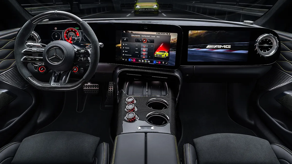 Luxurious car cockpit with a sporty steering wheel, digital instrument cluster, and wide central touchscreen. Carbon fiber trim and cup holders in the center console show high-end details.