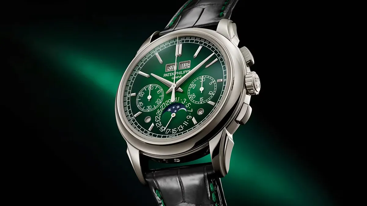 Green-dial luxury wristwatch with chronograph sub-dials, day/date window, and moon phase on a black leather strap.