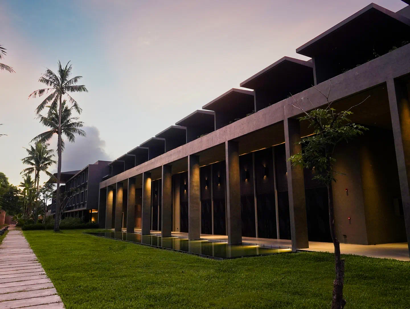 The exterior of the Dita Hall, the ballroom at the property, features columns and a reflecting pool. Amorita Palawan