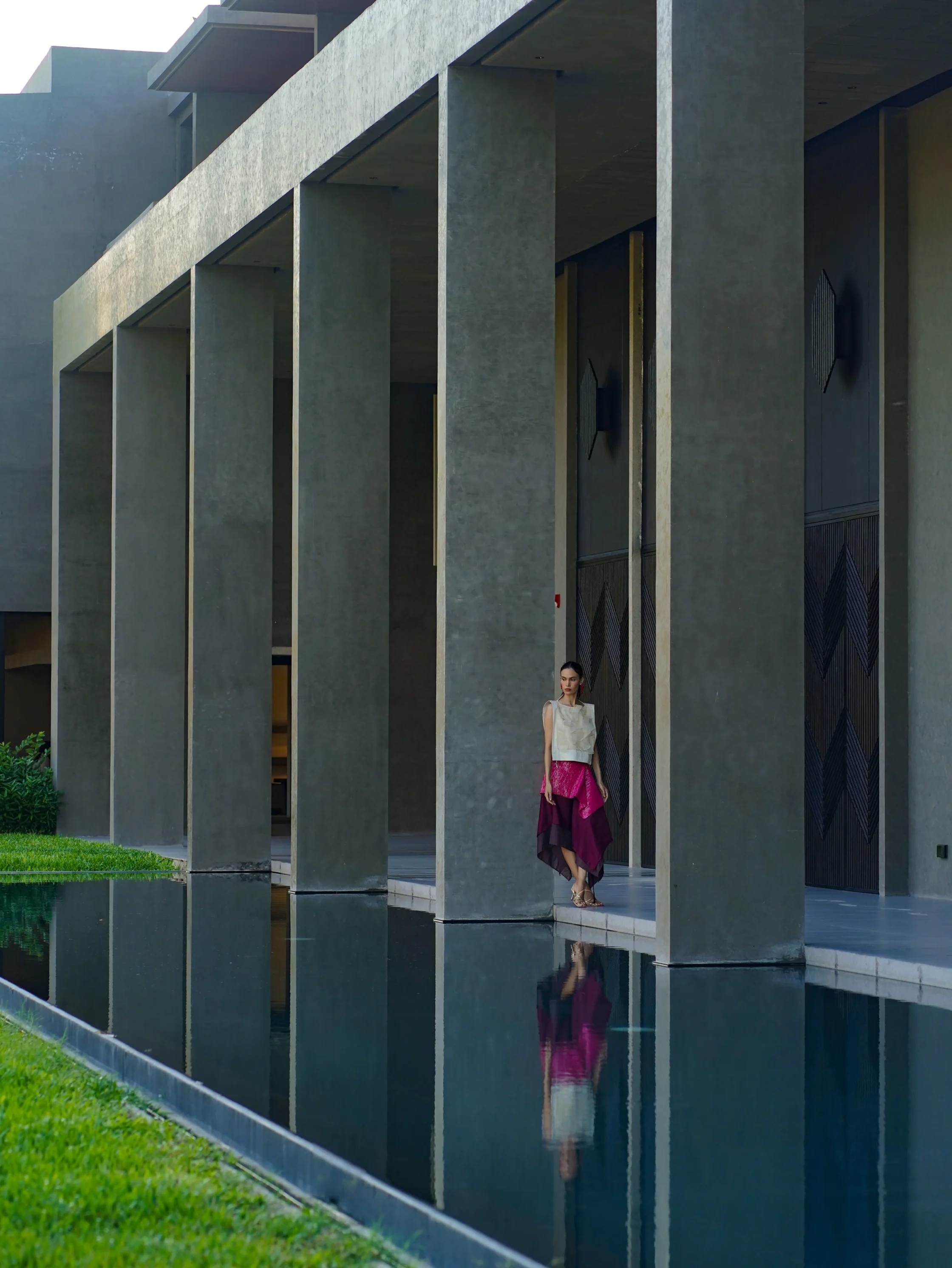 The exterior of Dita Hall, and its reflecting pool.