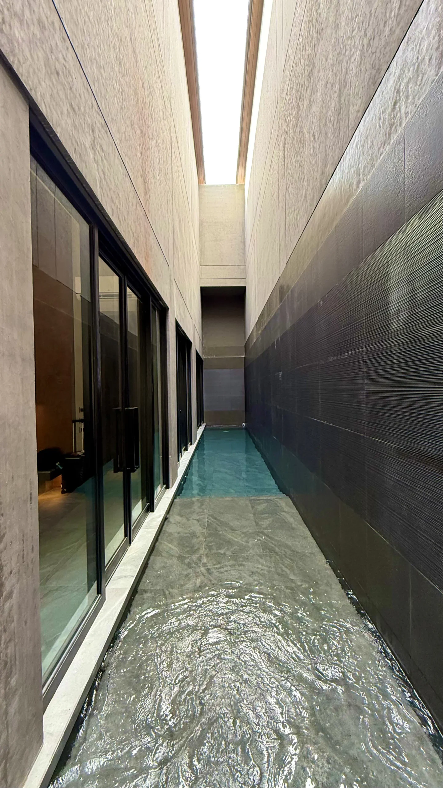 The pools run front-to-back of the villa.