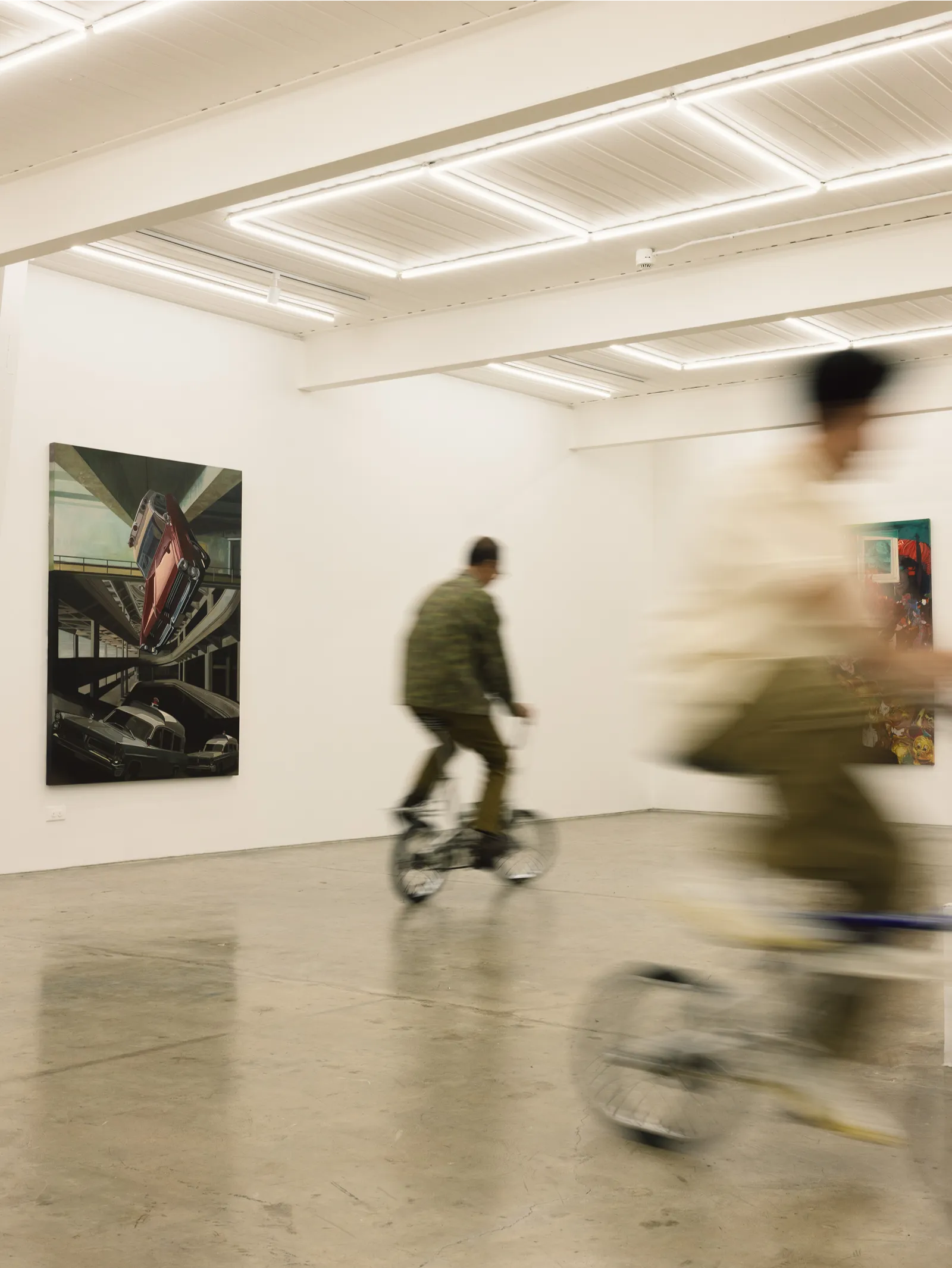 Jun Villalon and his son, Enzo, on vintage bikes around the gallery’s halls
